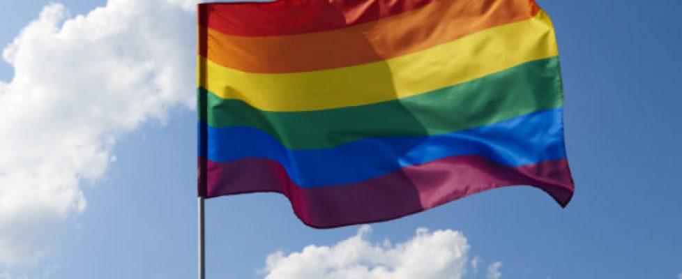 Close up of rainbow flag waving outside